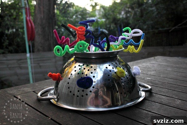 27 Creative Pipe Cleaner Crafts 11 Child wearing a silver colander robot hat decorated with curly pipe cleaners.