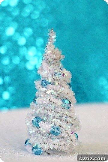 27 Creative Pipe Cleaner Crafts 26 Small DIY pipe cleaner Christmas trees decorated with glitter, perfect for holiday decor.