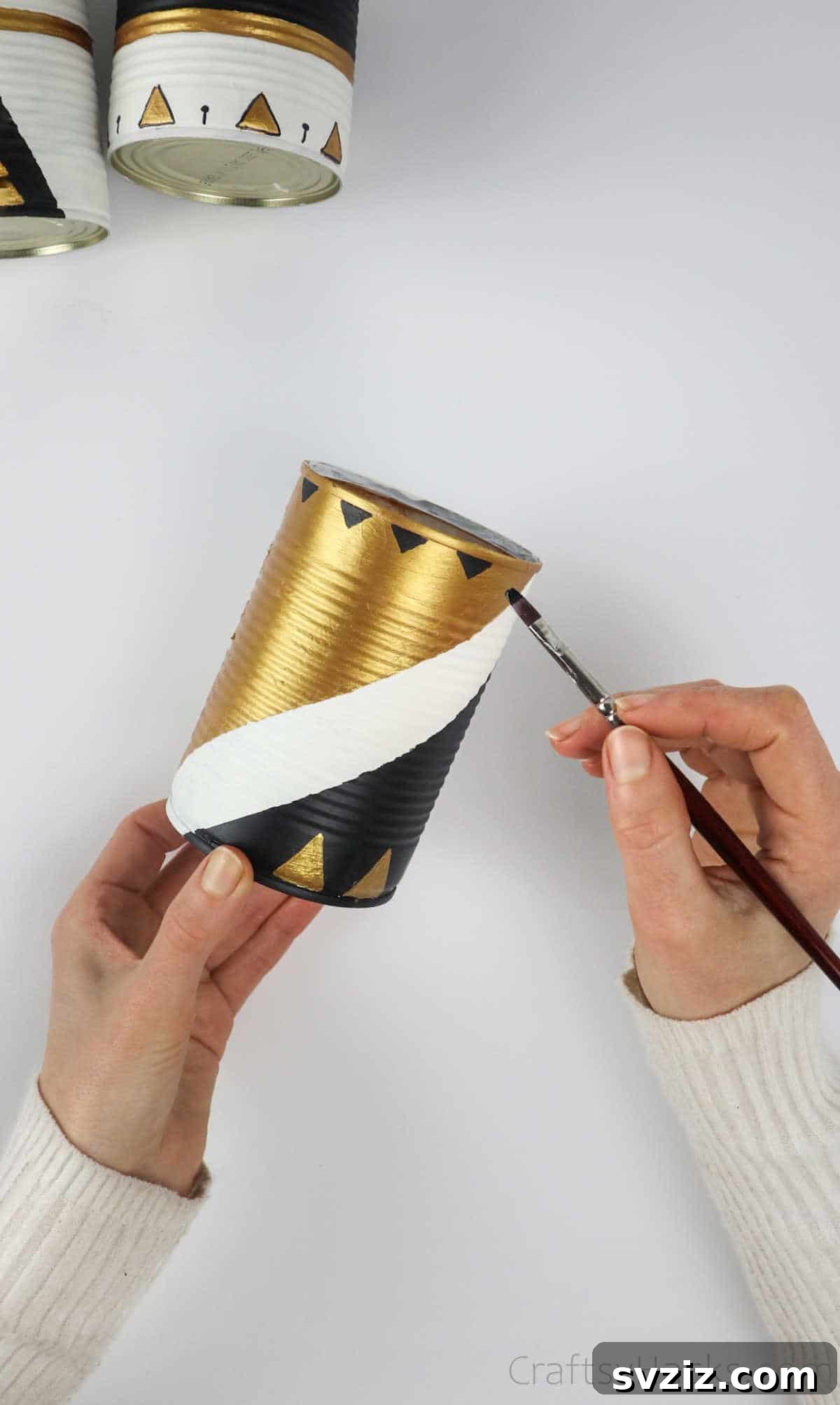 Repurposed Tin Treasures 13 Adding small painted triangle details to the patterns on an upcycled tin can