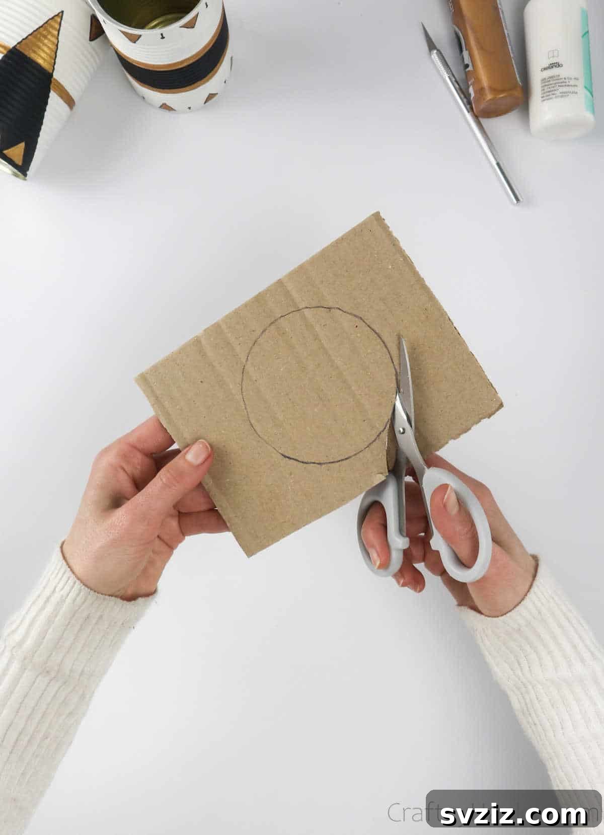 Repurposed Tin Treasures 15 Cutting out the traced cardboard circle with scissors to form the lid of the money box