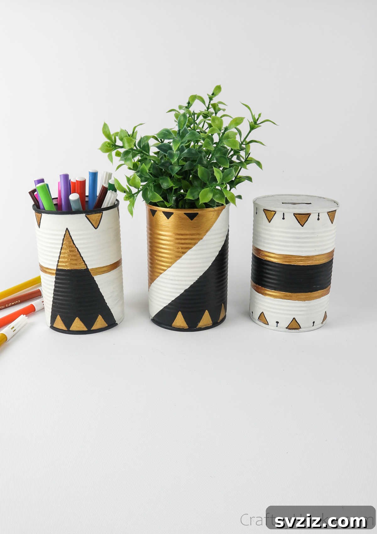 Repurposed Tin Treasures 25 A collection of upcycled tin cans used for various purposes: holding pens, a small plant, and other desk items