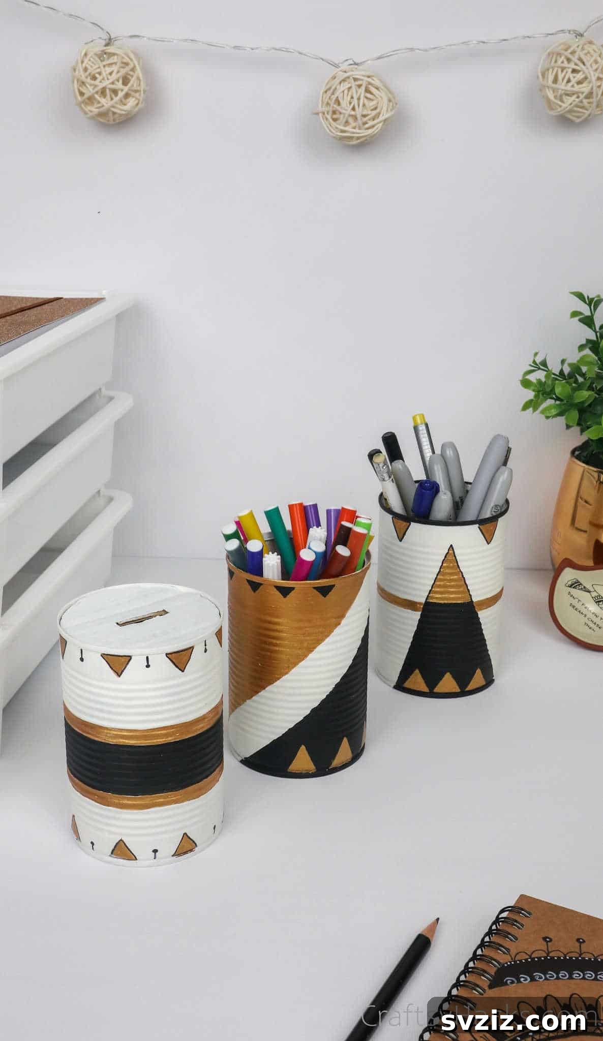 Repurposed Tin Treasures 4 A trio of decorative upcycled tin cans neatly arranged on a modern desk setup