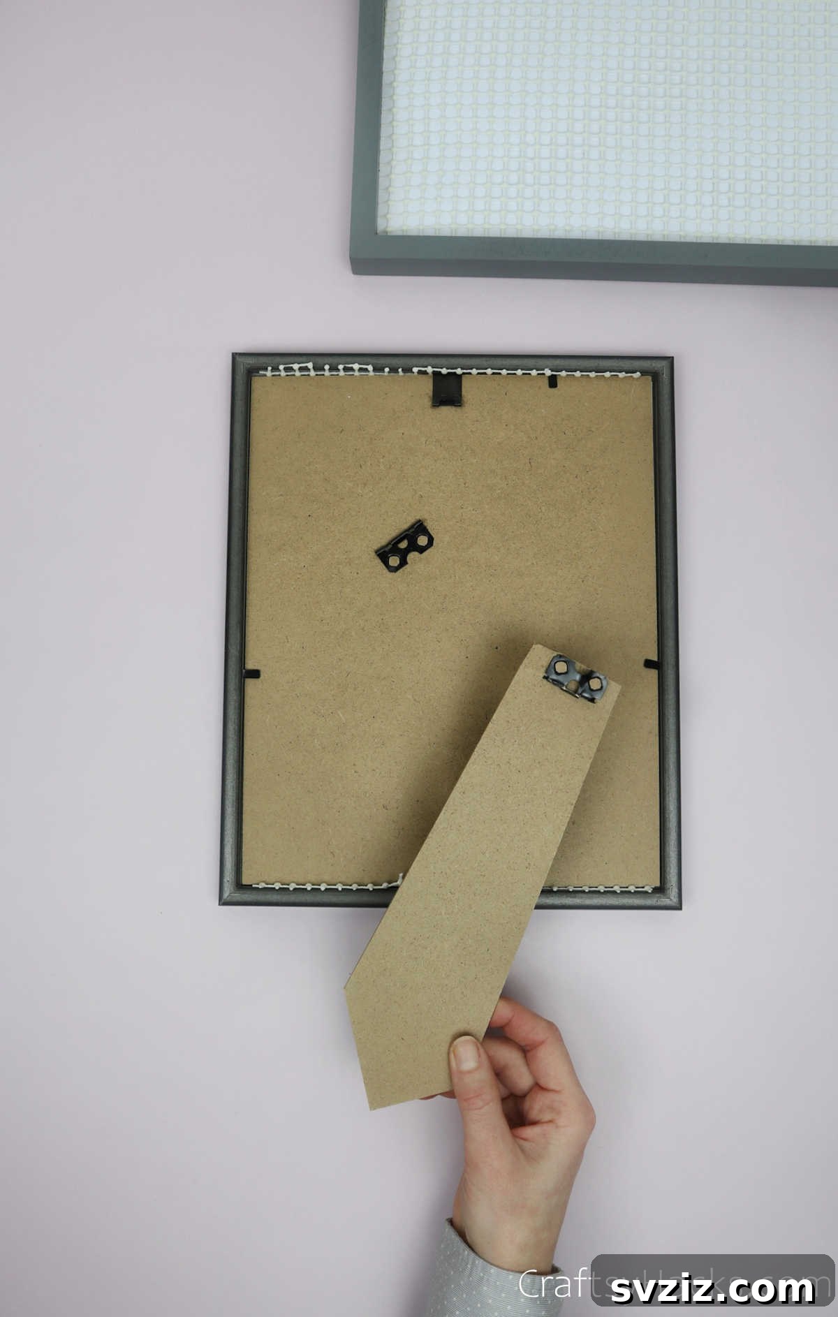 Turn Old Frames into a Chic Earring Organizer 12 Demonstration of removing the stand from the frame, indicating versatility for hanging
