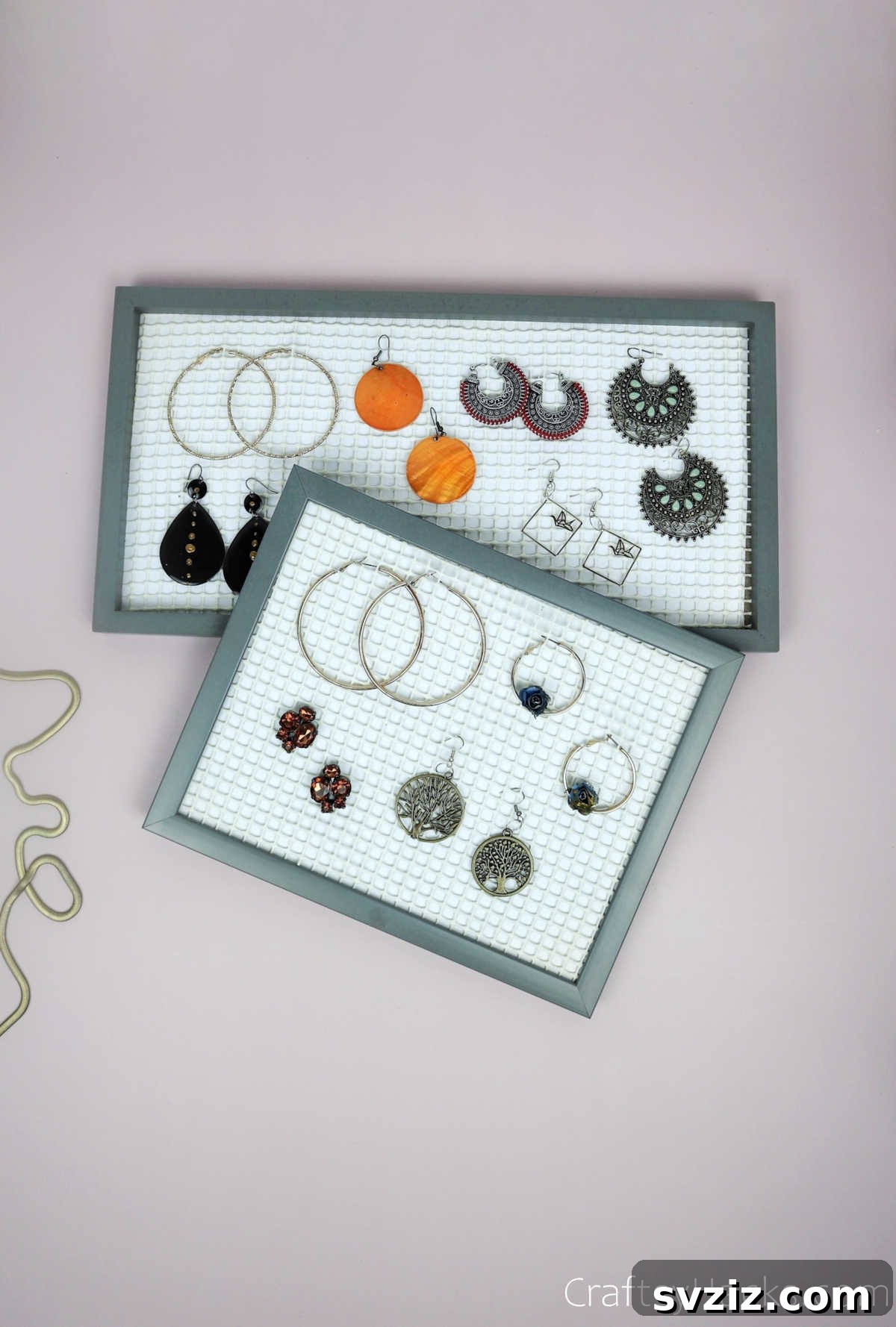 Turn Old Frames into a Chic Earring Organizer 17 Close-up of three DIY earring organizers, each full of various earrings, demonstrating effective storage
