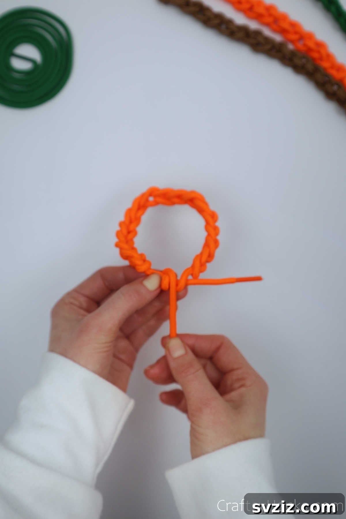 holding orange bracelet
