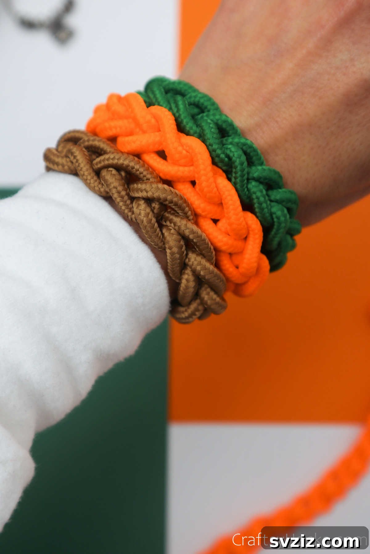 green, orange, and brown DIY bracelets on wrist