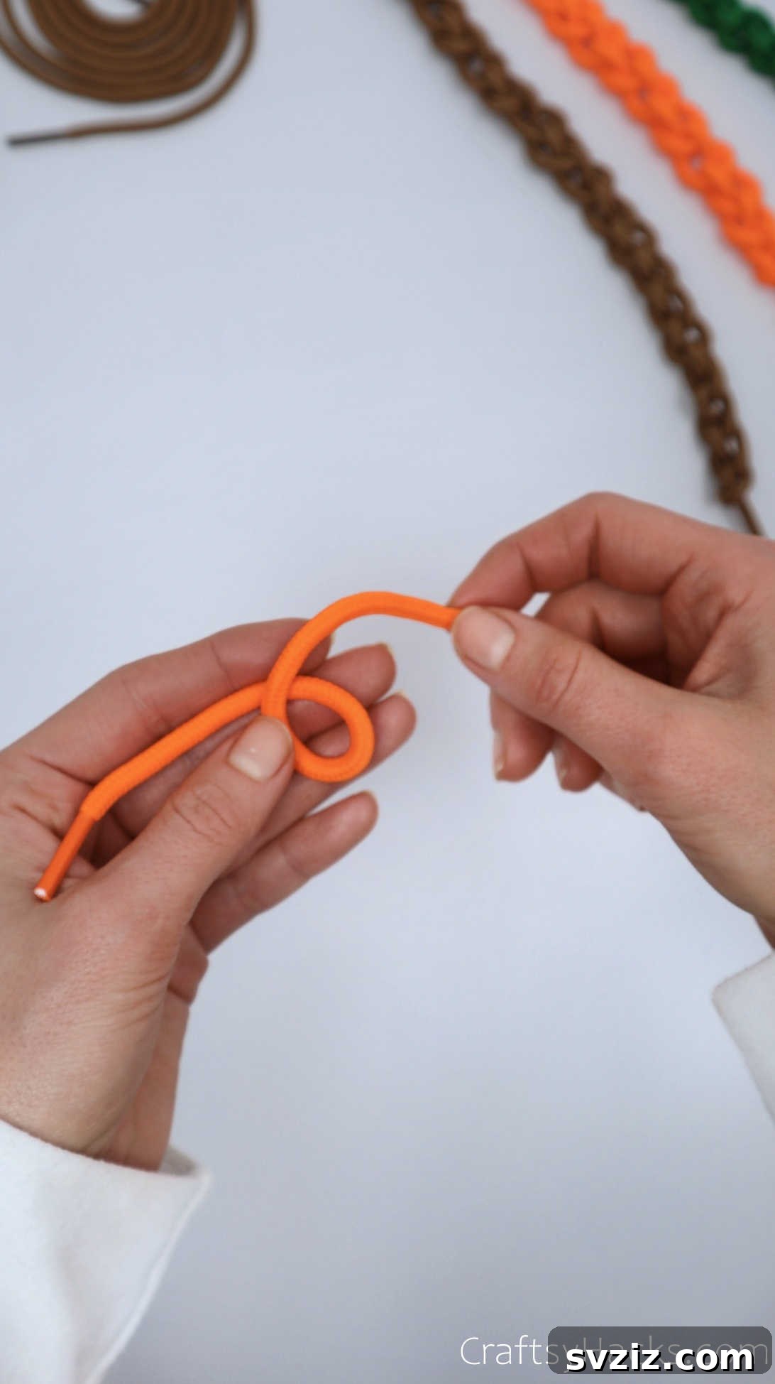 holding orange shoelace