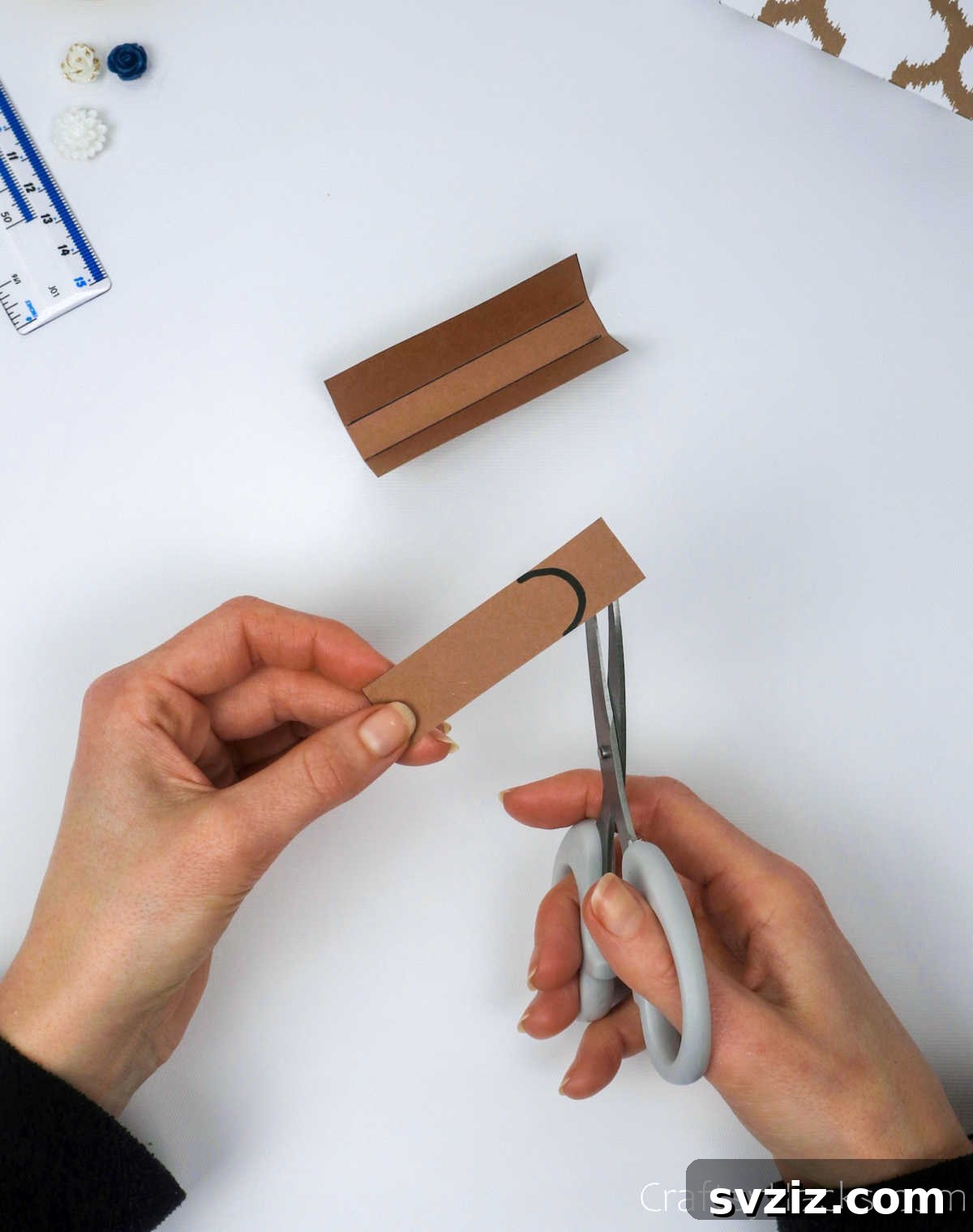Homemade Touch: Custom Gift Bags 30 Cutting a strip of paper into an arc shape to create the lid's tongue or flap.