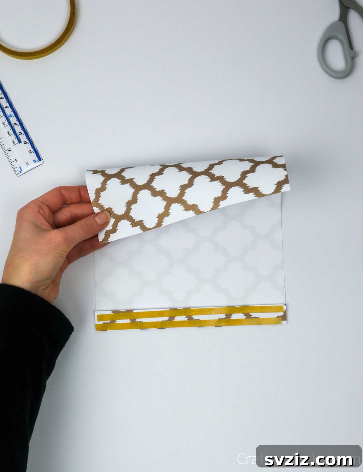 Homemade Touch: Custom Gift Bags 7 Applying double-sided tape along the folded edge of the paper.