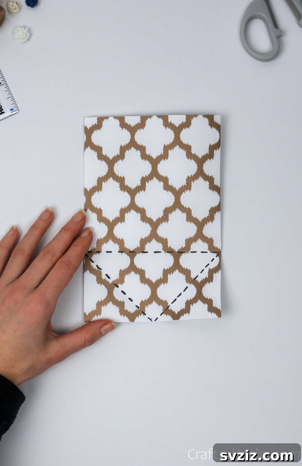 Homemade Touch: Custom Gift Bags 10 Paper with dotted lines drawn to guide the inward folding of the side edges, forming triangles at the bottom.