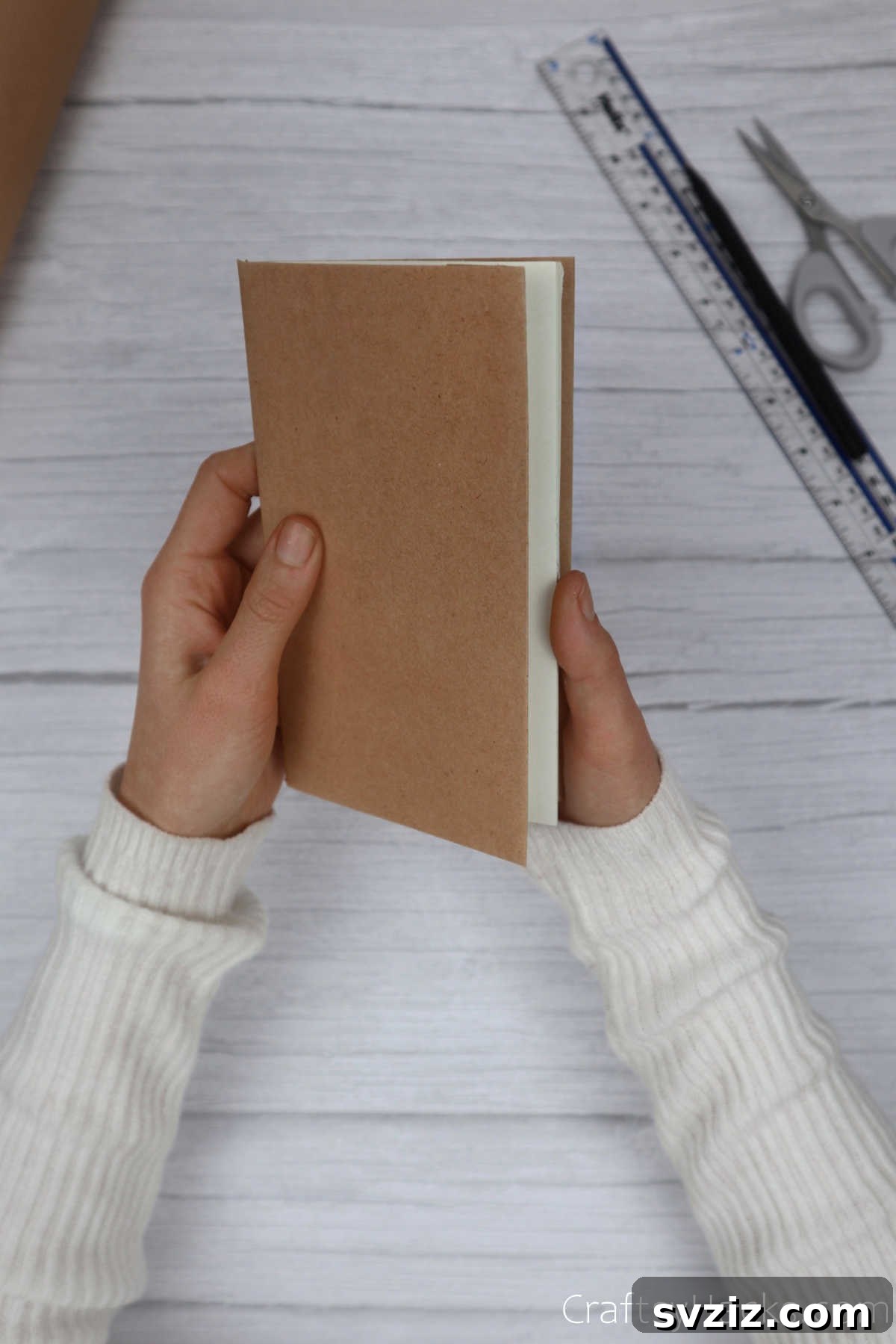 Make Your Journal Cover Unique 18 A finished DIY journal cover, neatly wrapped in kraft paper with inner panels, ready for artistic decoration.