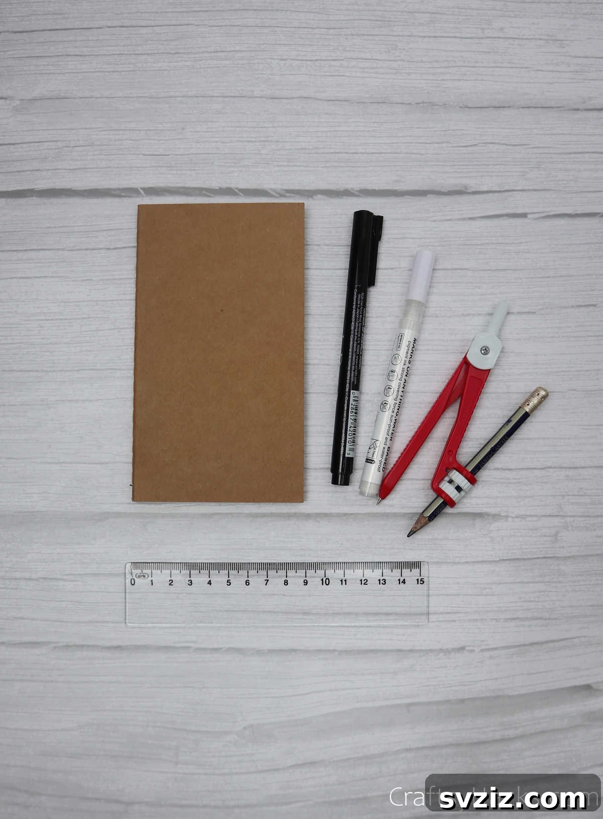 Make Your Journal Cover Unique 19 A collection of drawing supplies including rulers, markers, and a compass with a pencil, laid out for journal decoration.