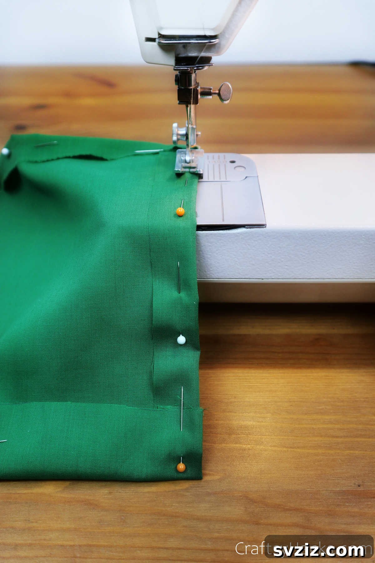 Sewing a green fabric pocket onto the main caddy body