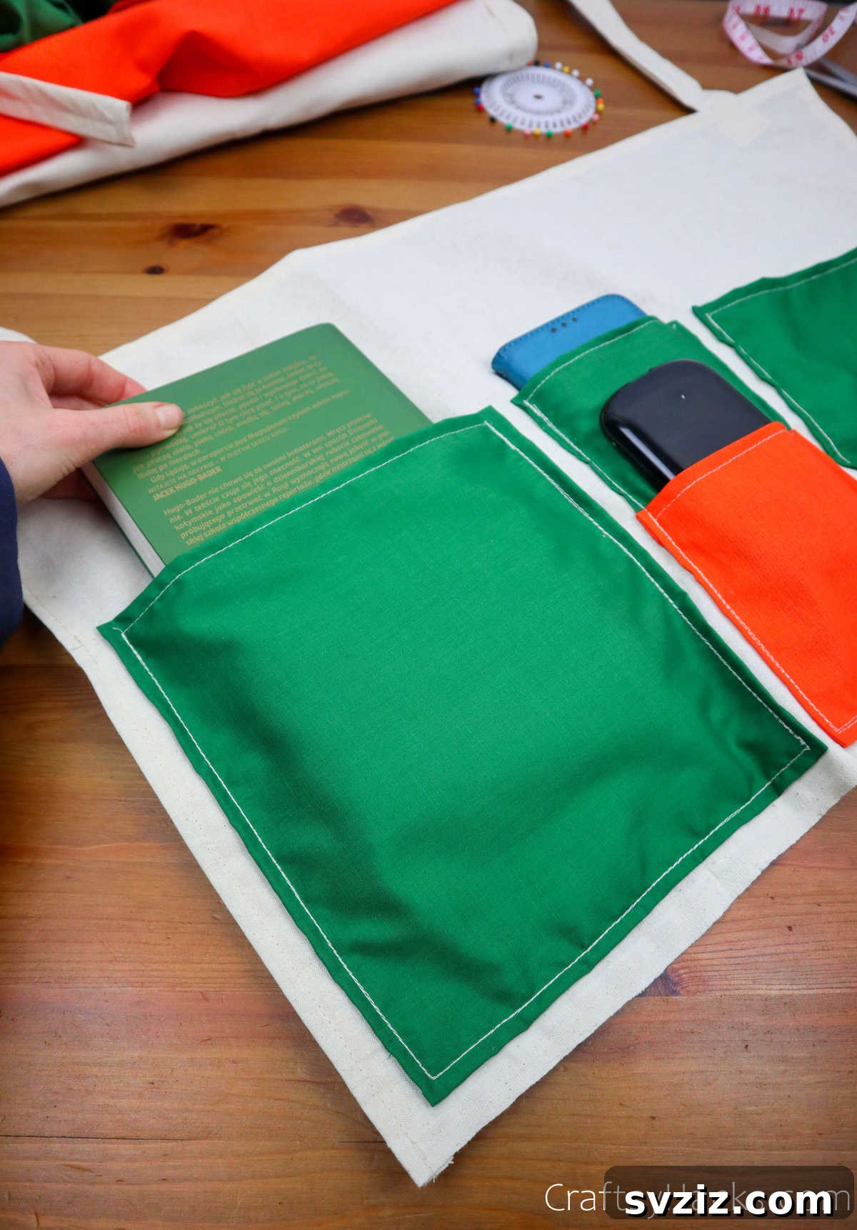 Putting books into the pockets of the bedside caddy