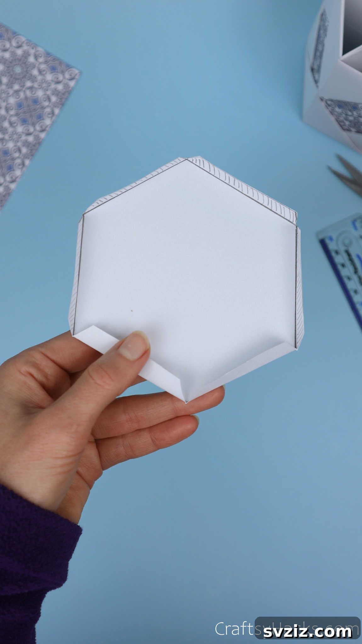 The cut-out hexagonal base with all its perimeter flaps folded neatly upwards, demonstrating its readiness for insertion into the pencil holder body.