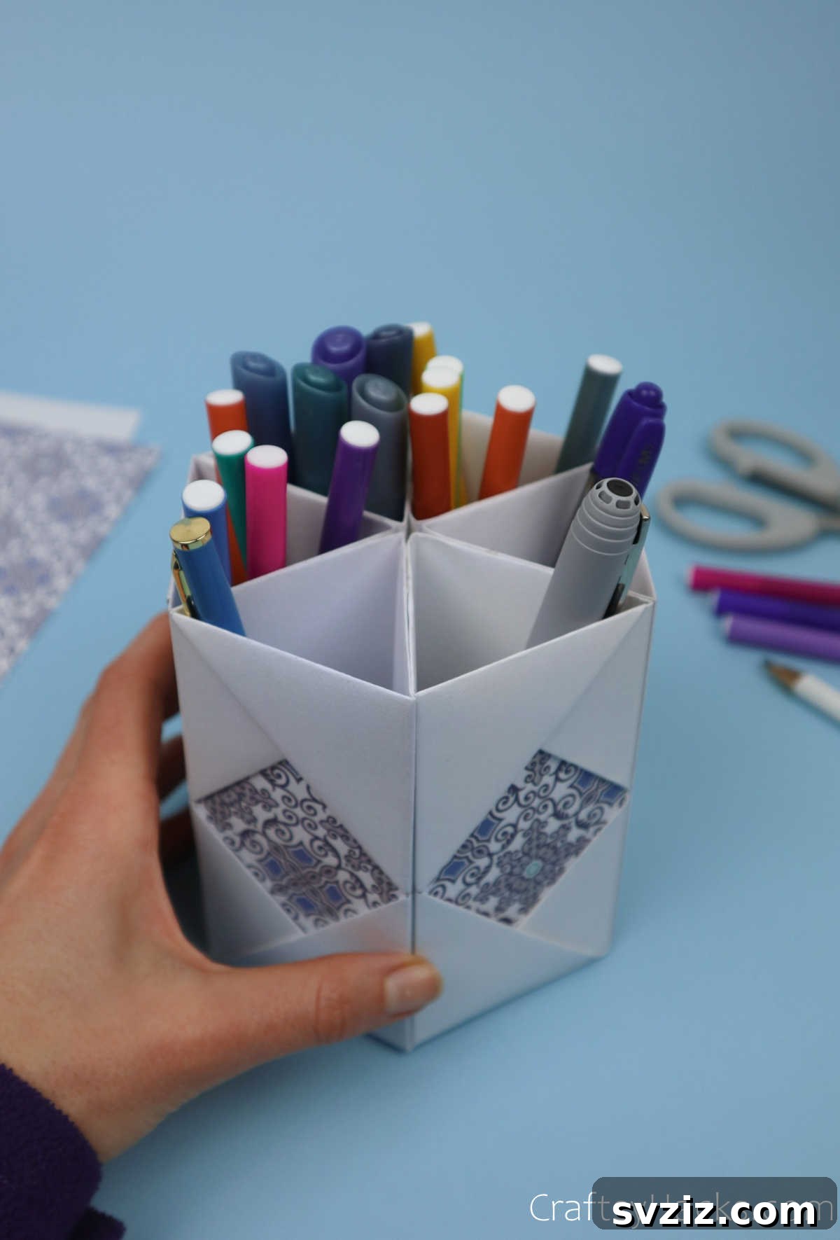 Close-up view of the DIY paper organizer, filled with various colored pens, highlighting its practical and aesthetic appeal for stationery storage.
