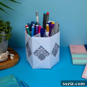 Detailed image of the DIY paper pencil holder craft from above, showcasing its hexagonal compartments.