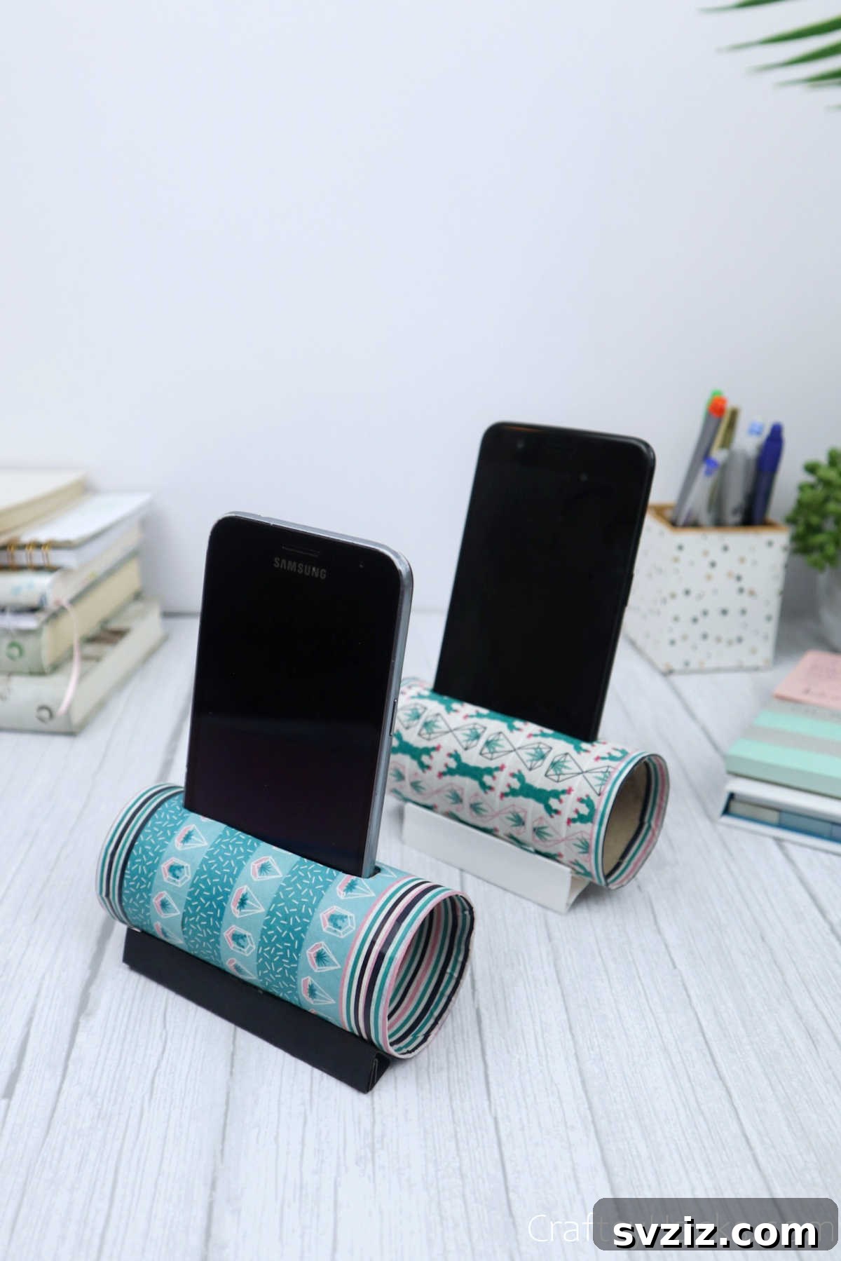 Roll Your Own Phone Stand from a Toilet Paper Tube 2 Two vibrant DIY phone holders crafted from toilet paper rolls, showcasing creative decoration and functionality.