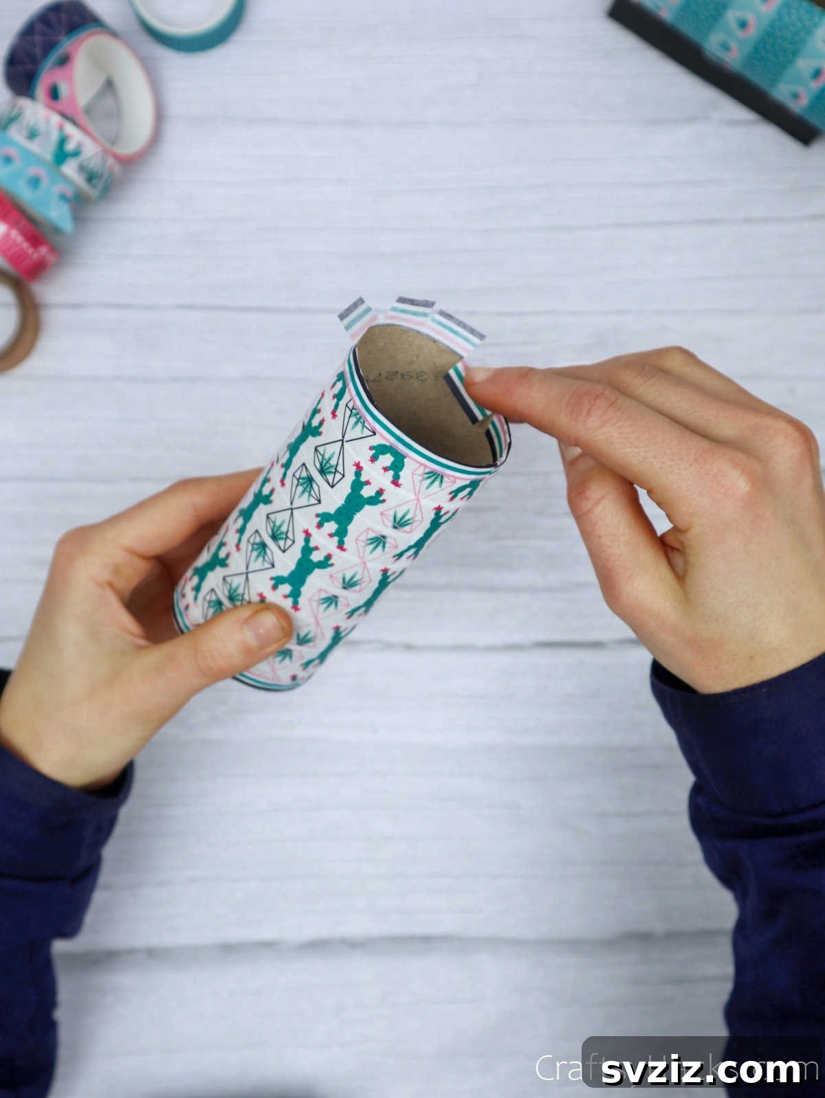 Roll Your Own Phone Stand from a Toilet Paper Tube 13 Washi tape flaps neatly tucked inside the toilet paper roll, creating a smooth, finished interior edge.