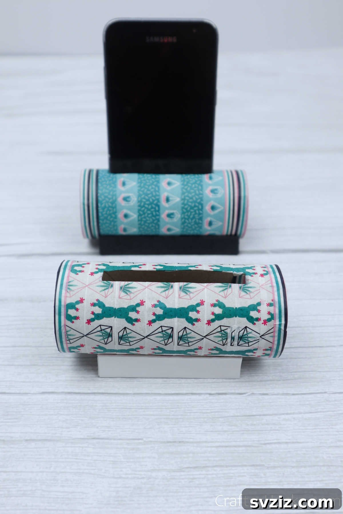 Roll Your Own Phone Stand from a Toilet Paper Tube 3 Close-up view of a beautifully decorated DIY phone holder, highlighting intricate washi tape patterns.
