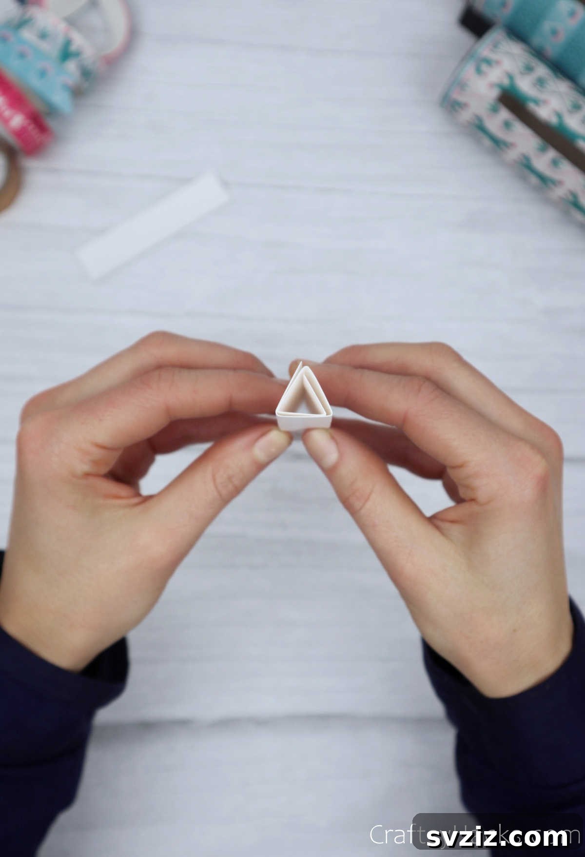 Roll Your Own Phone Stand from a Toilet Paper Tube 24 A perfectly formed and secured paper triangle, showcasing the finished leg component.