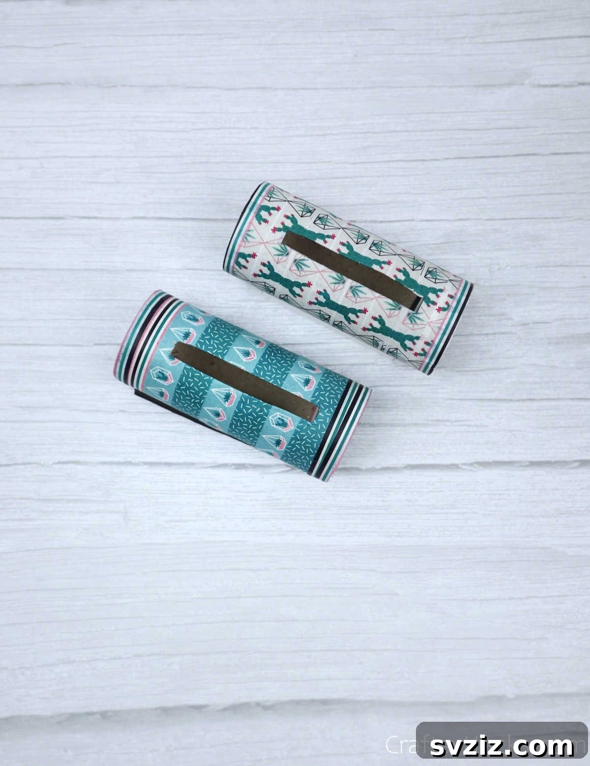 Roll Your Own Phone Stand from a Toilet Paper Tube 27 Two distinct completed DIY phone holders, showcasing creative designs and functional stands.