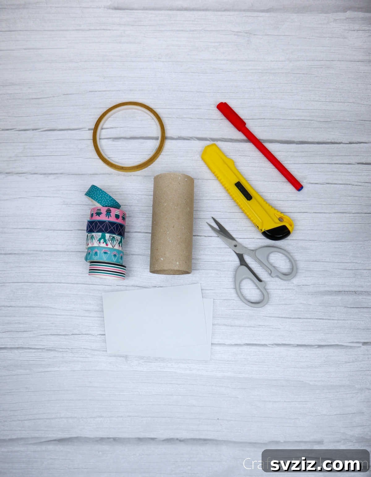 Roll Your Own Phone Stand from a Toilet Paper Tube 5 A neat arrangement of craft supplies, including washi tape, scissors, a marker, and a toilet paper roll, ready for the DIY project.