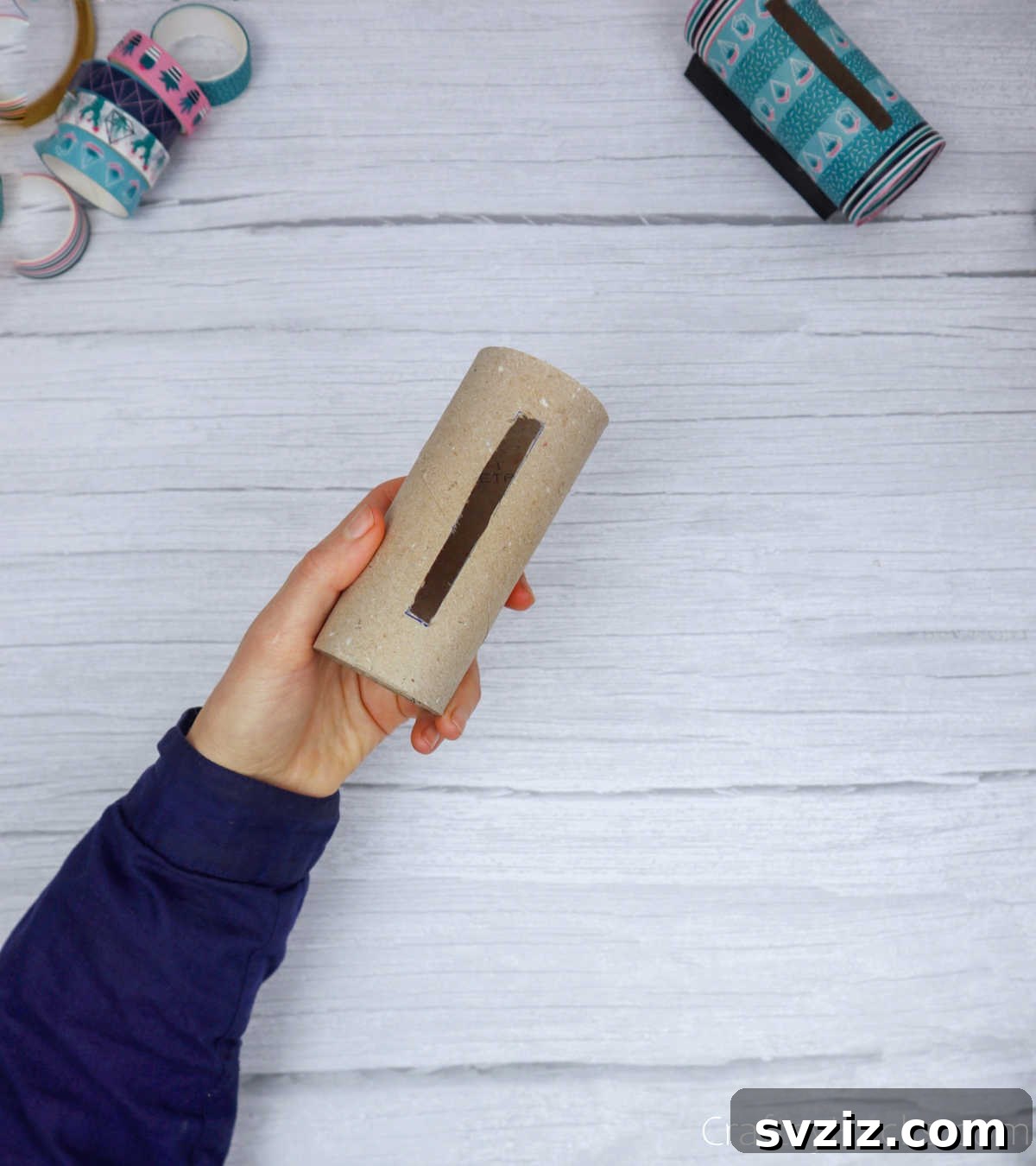 Roll Your Own Phone Stand from a Toilet Paper Tube 8 A toilet paper roll with a precisely cut phone-sized slot, ready for decoration.