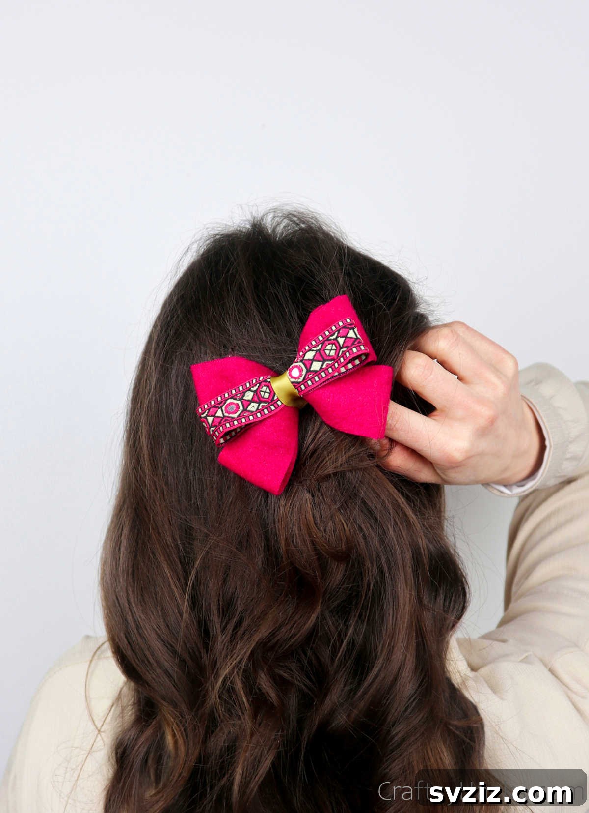 A stunning pink hair bow adorning a hairstyle, showcasing a beautiful handmade accessory