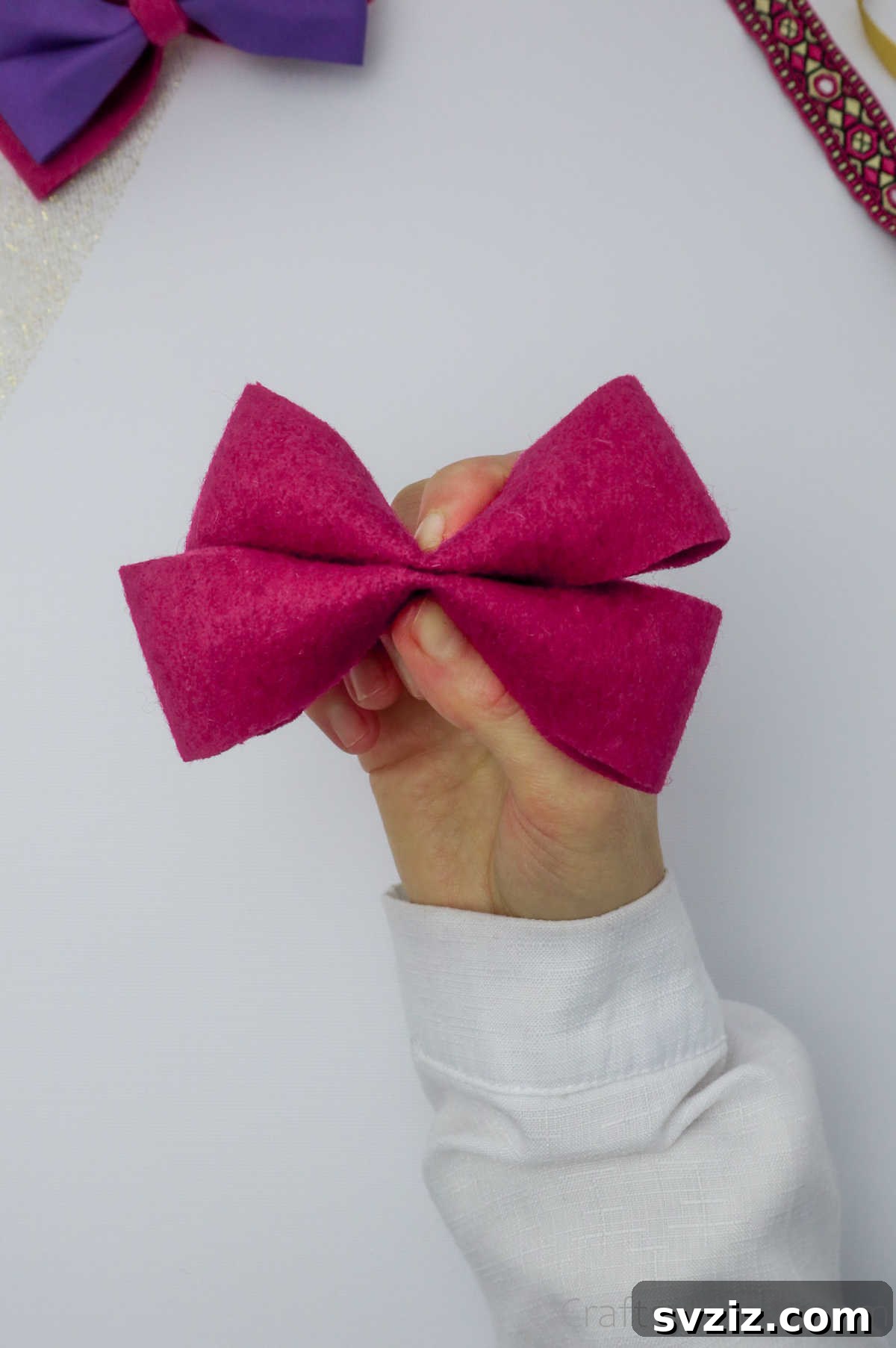 Two pink felt pieces securely glued together, forming the robust and layered foundation of the hair bow