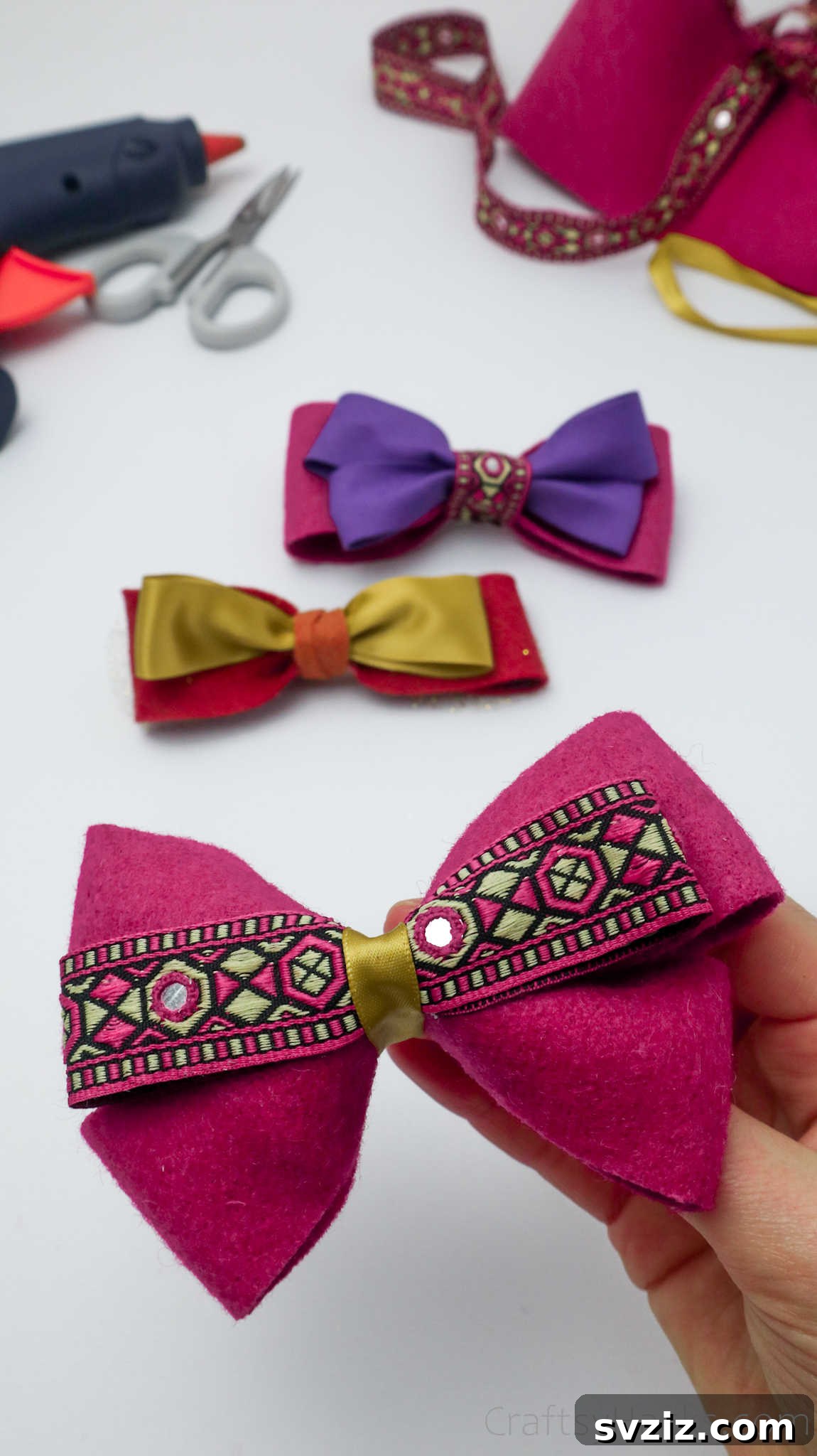 Close-up of hands holding a beautifully crafted pink DIY hair bow, ready for styling