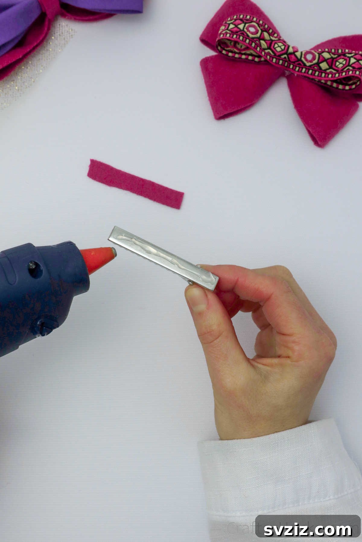Hot glue applied to a metal crocodile hair clip, with a small piece of felt being attached to cover the metal