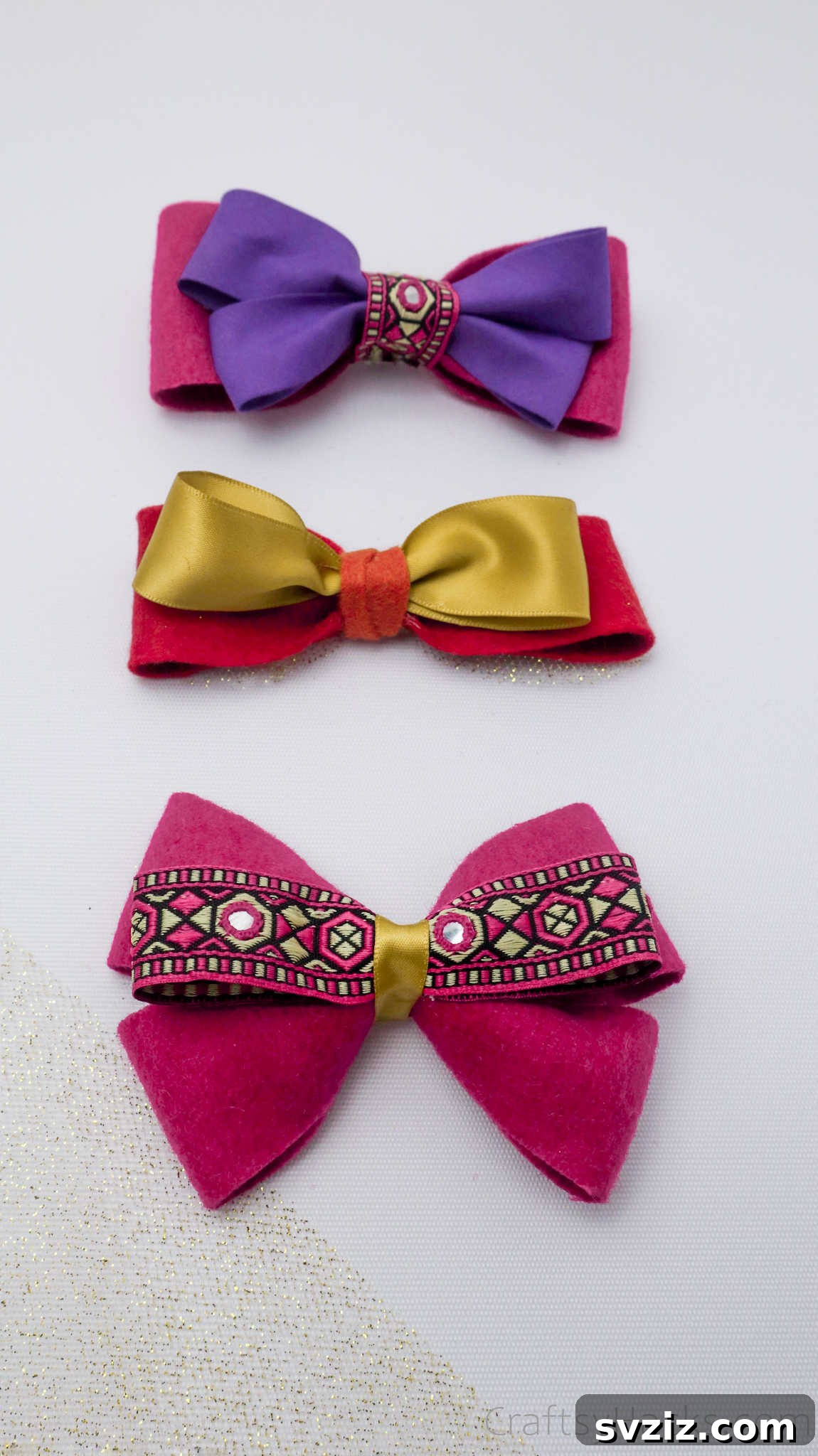 A trio of beautifully finished DIY hair bows, showcasing different colors and textures, ready to accessorize