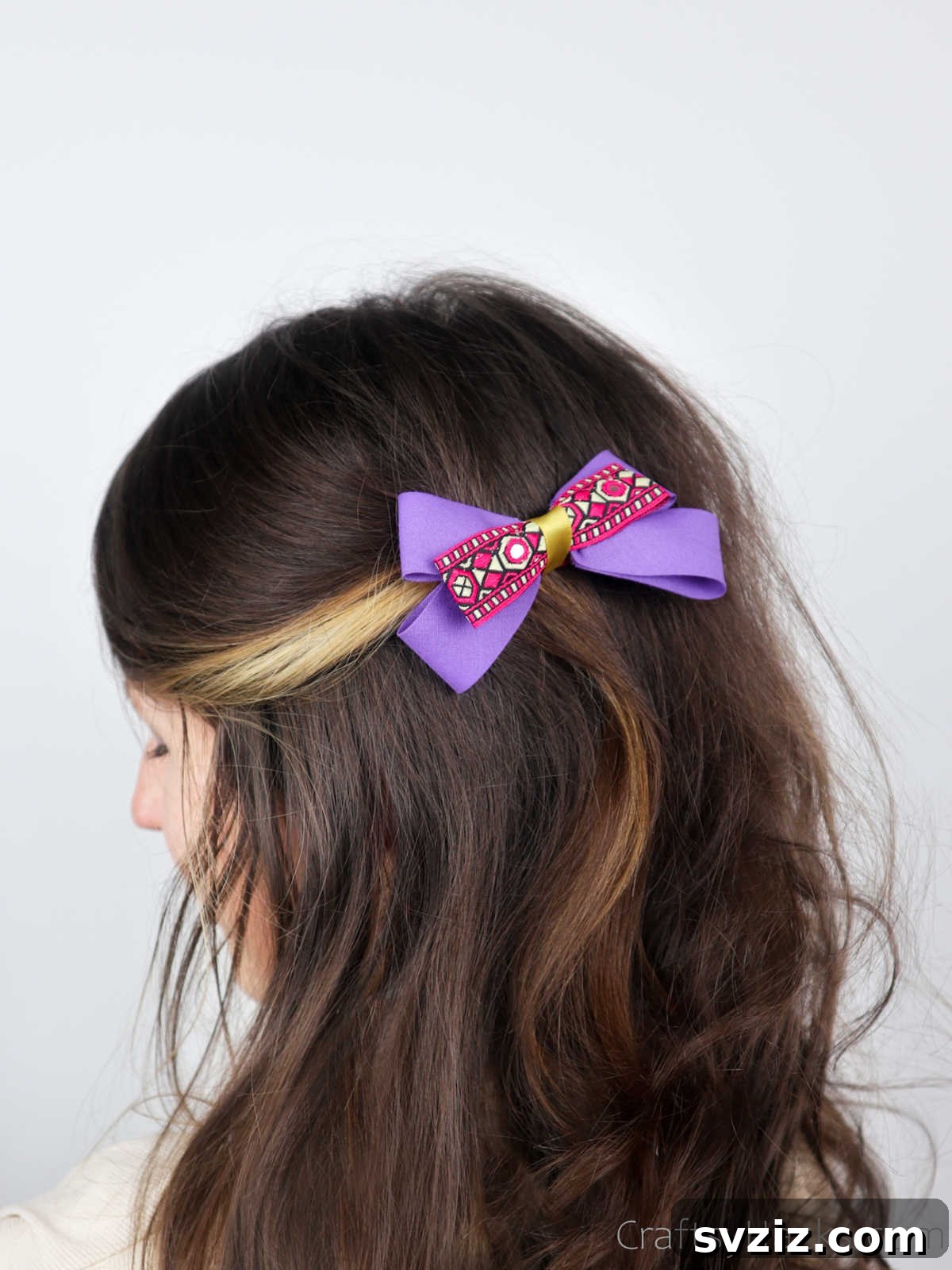 A vibrant purple hair bow gracefully styled in hair, demonstrating a chic DIY accessory
