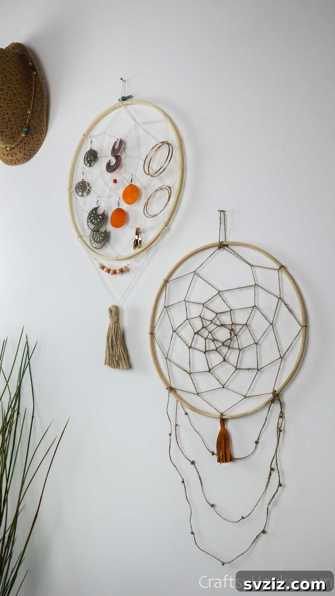 From Clutter to Charm: DIY Jewelry Storage 3 A closer view of two beautiful DIY dreamcatcher jewelry organizers hanging on a wall, showcasing a neat arrangement of earrings. The top organizer has a tightly woven white web, while the bottom one features a more open, dual-toned white and beige pattern.