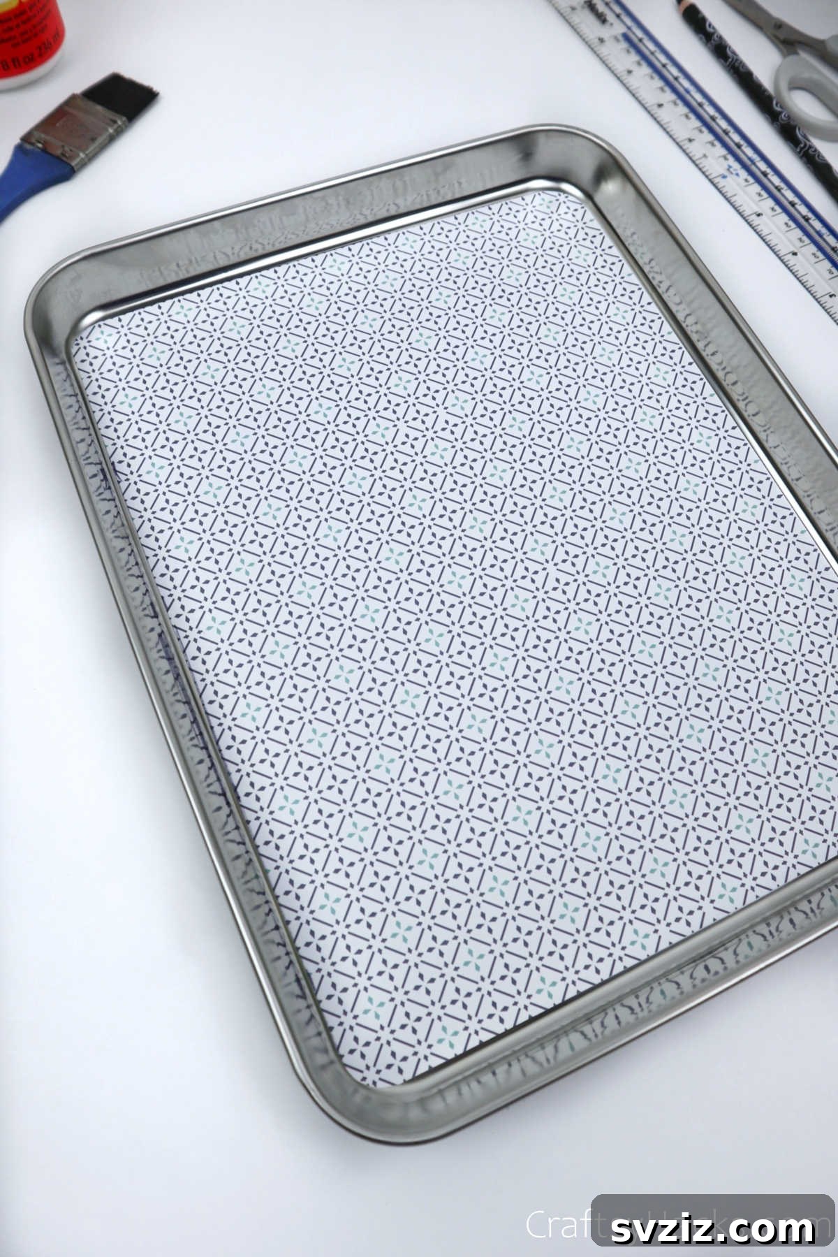 Glued decorative paper drying on a tray