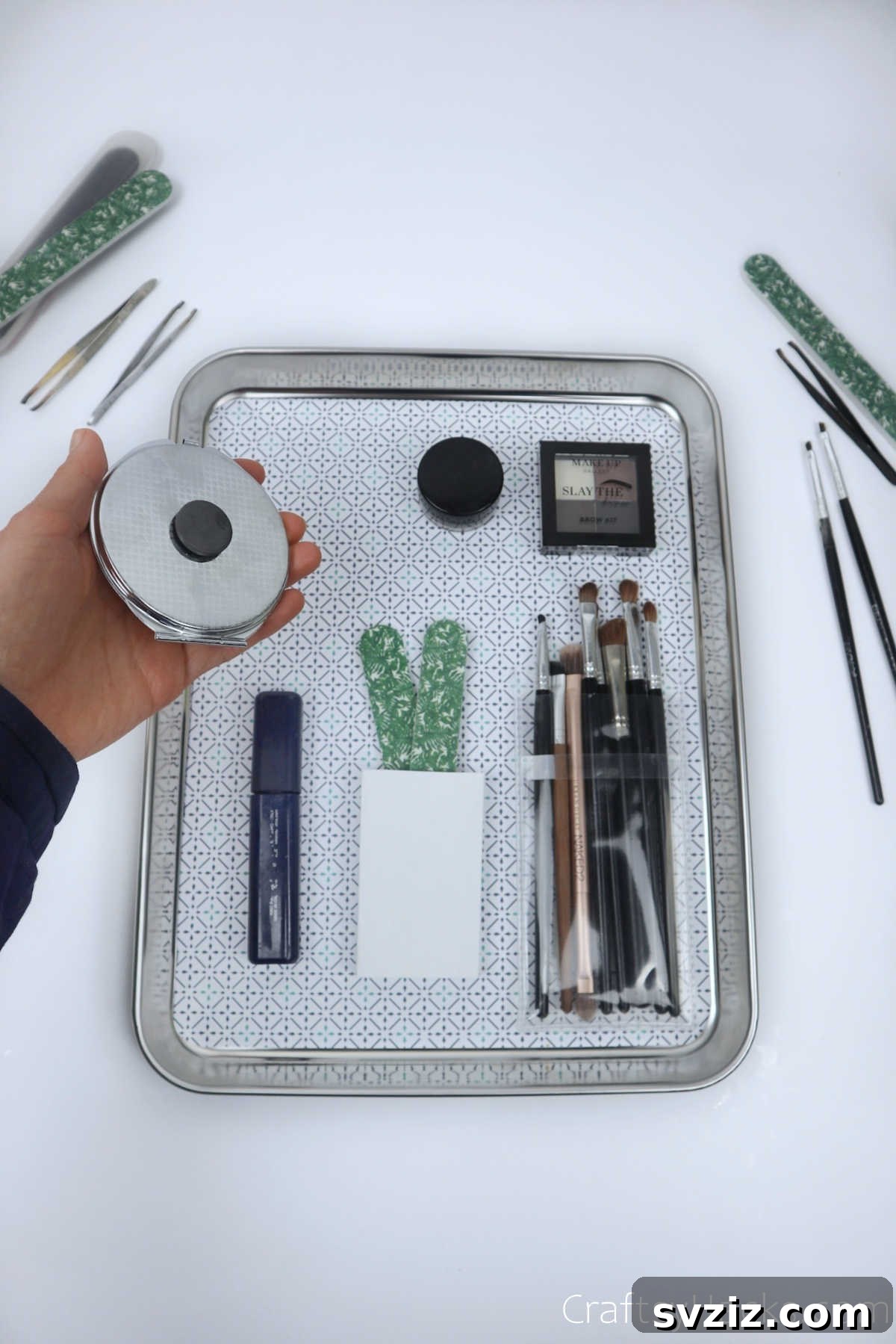 Placing magnetized makeup items onto a decorative tray