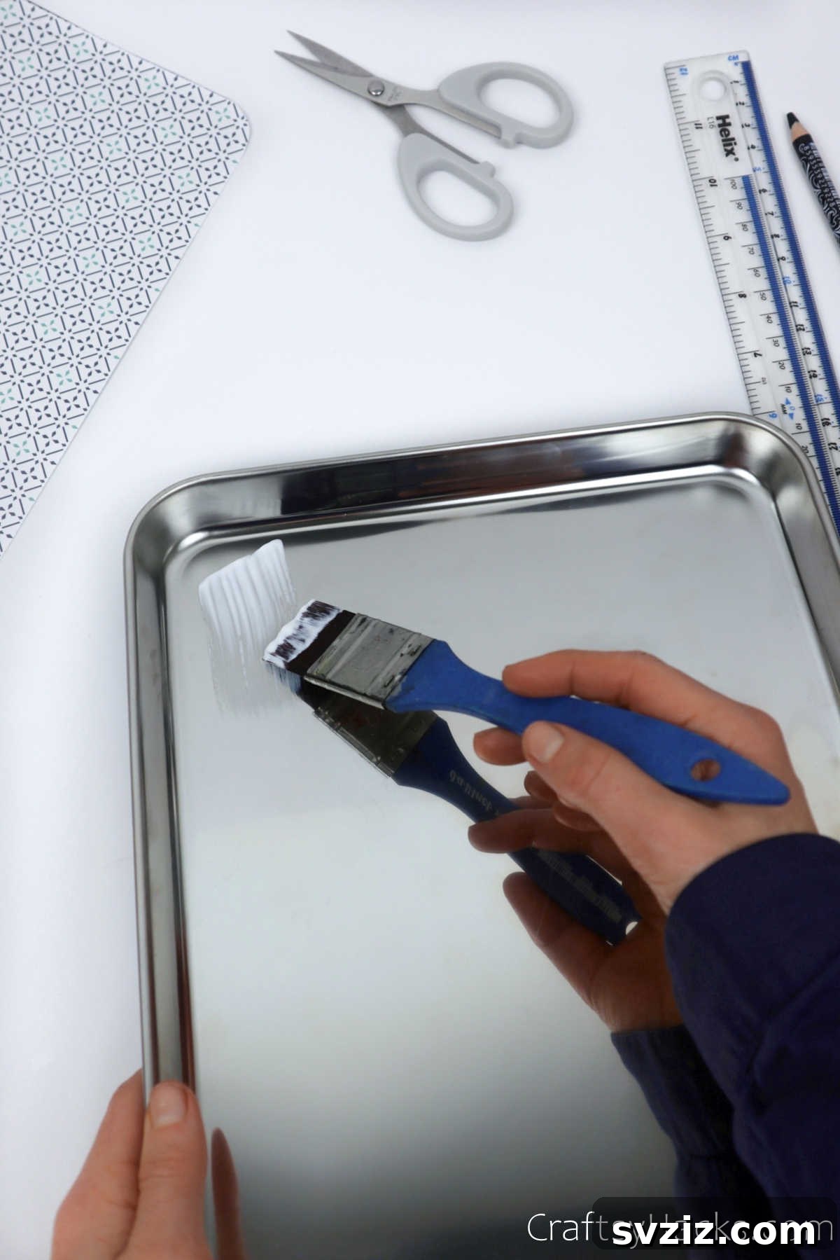 Applying Mod Podge to a tray for a DIY project