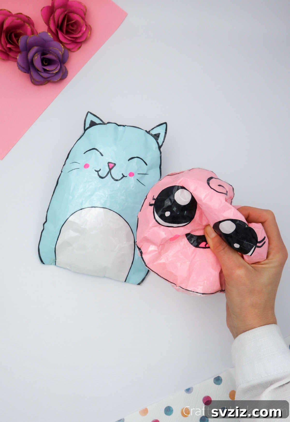 Create Adorable Paper Squishies Print Play 2 Pink paper squishy held in hands, a perfect DIY kids' craft project.