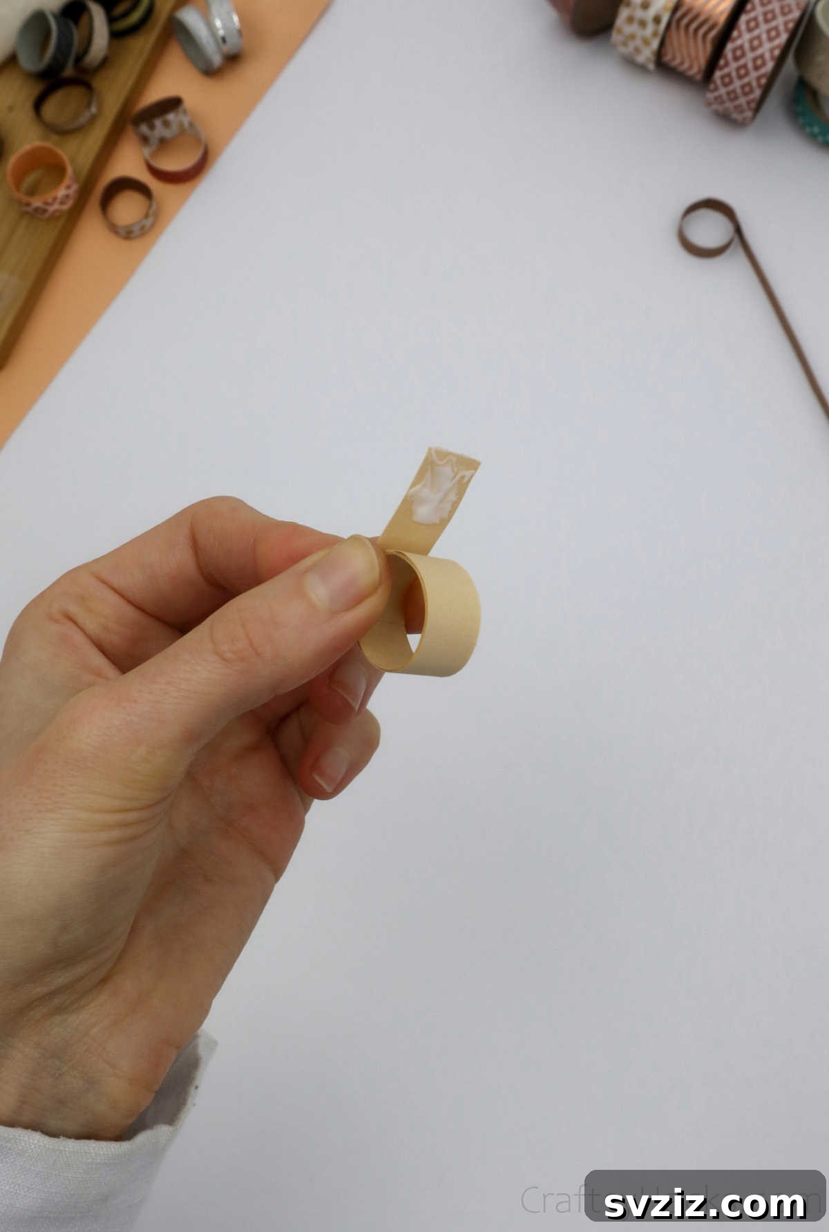 Craft Your Own Paper Ring 14 glueing ends of paper