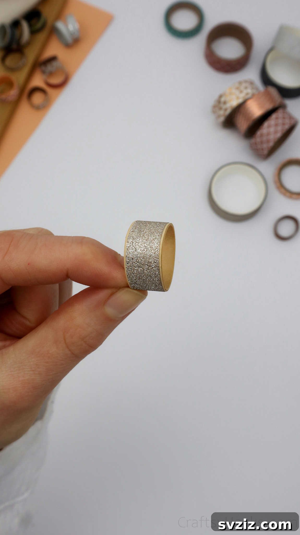 Craft Your Own Paper Ring 21 holding silver paper ring