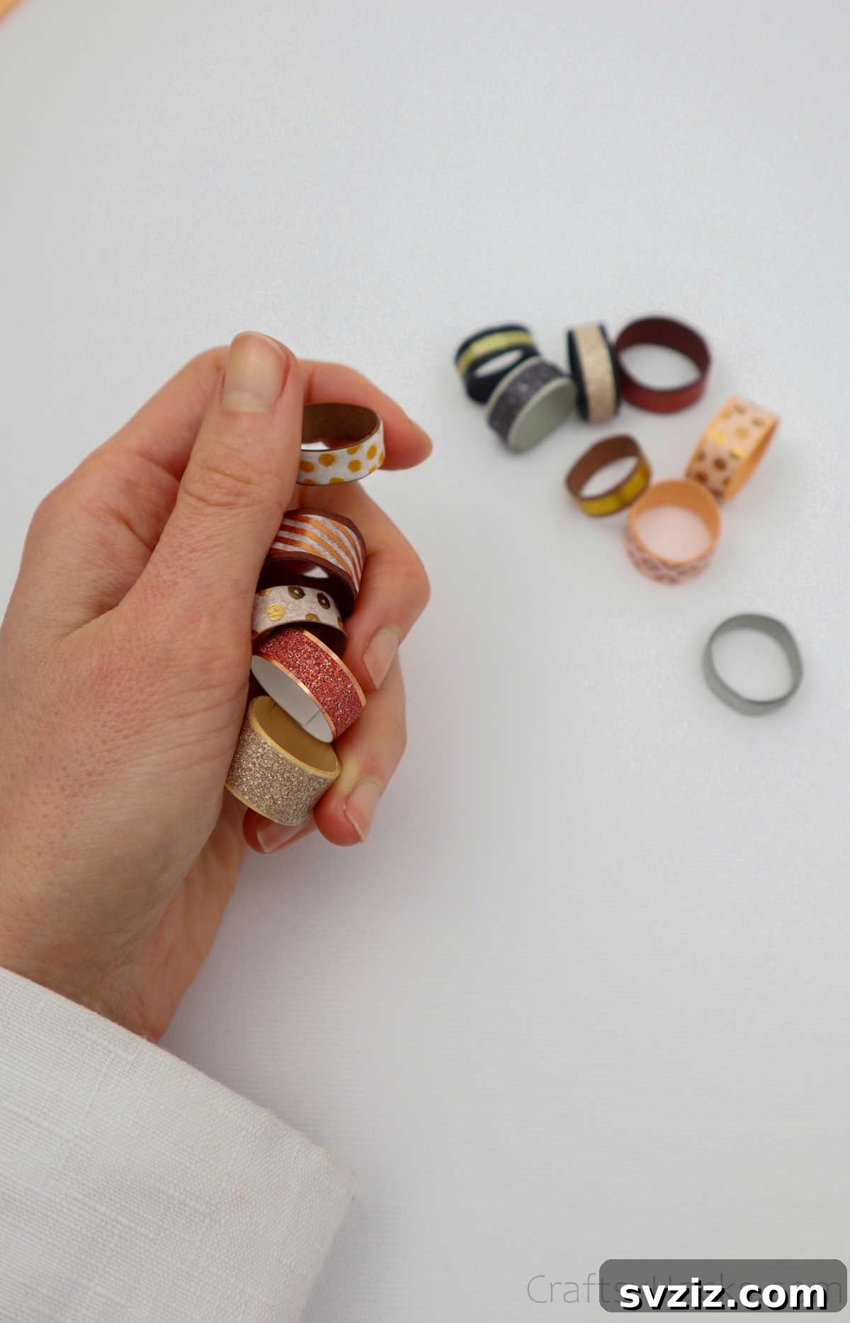 Craft Your Own Paper Ring 4 holding handful of paper rings