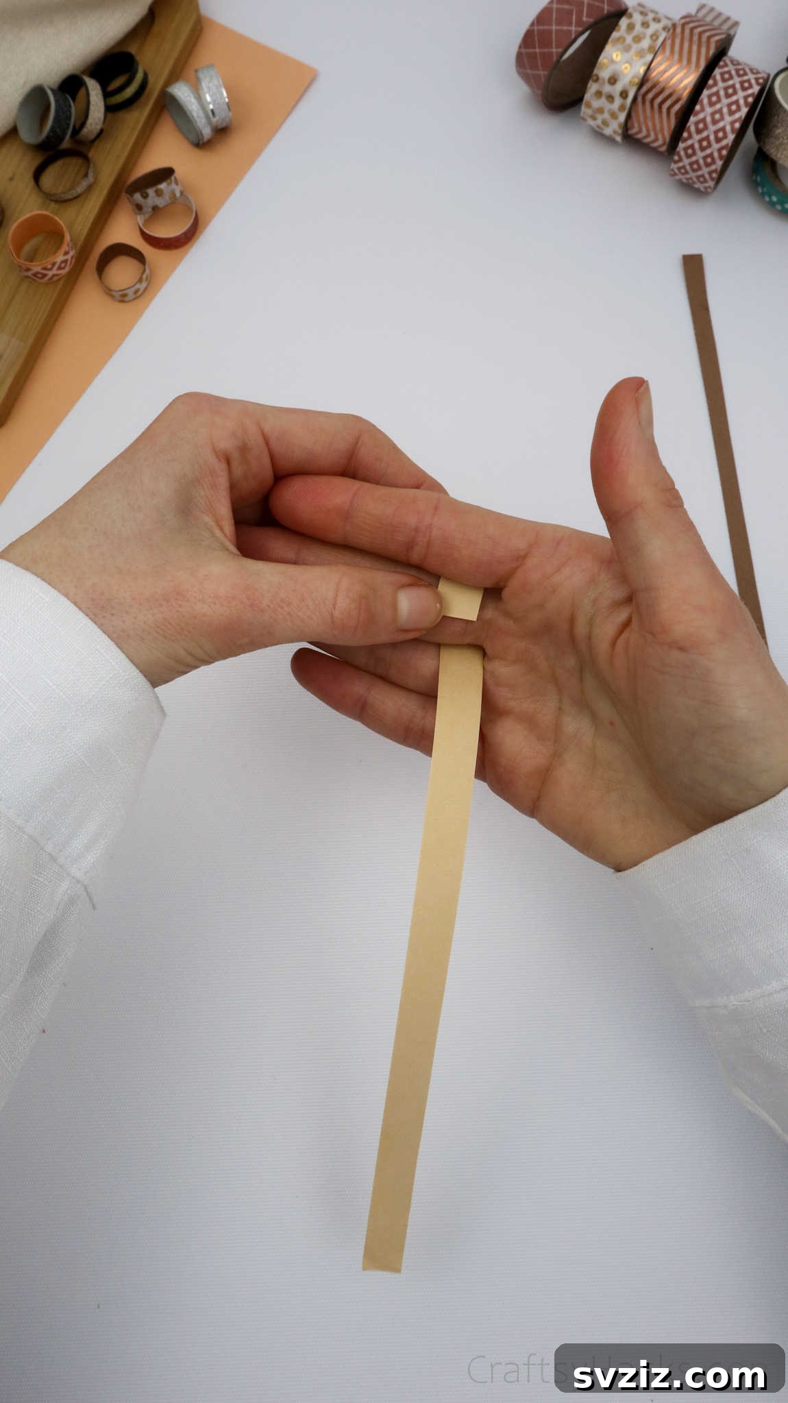 Craft Your Own Paper Ring 8 holding strip of paper