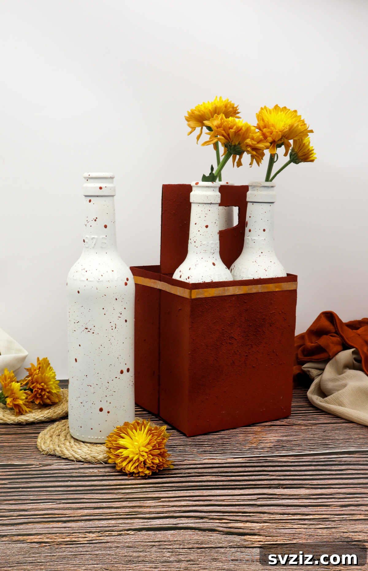 Completed DIY table centerpiece made from upcycled beer bottles and carrier