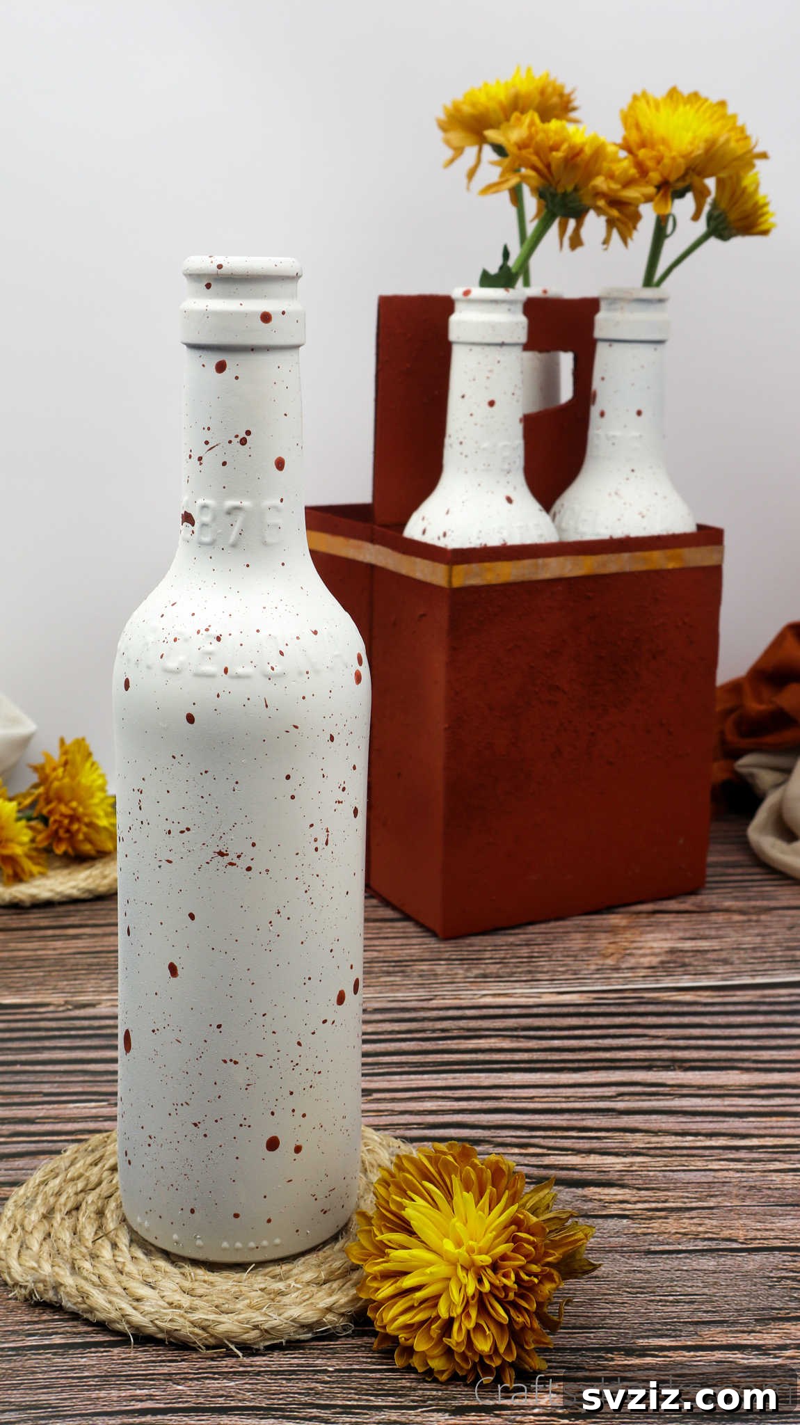 Bottle with paint splatter for DIY centerpiece project