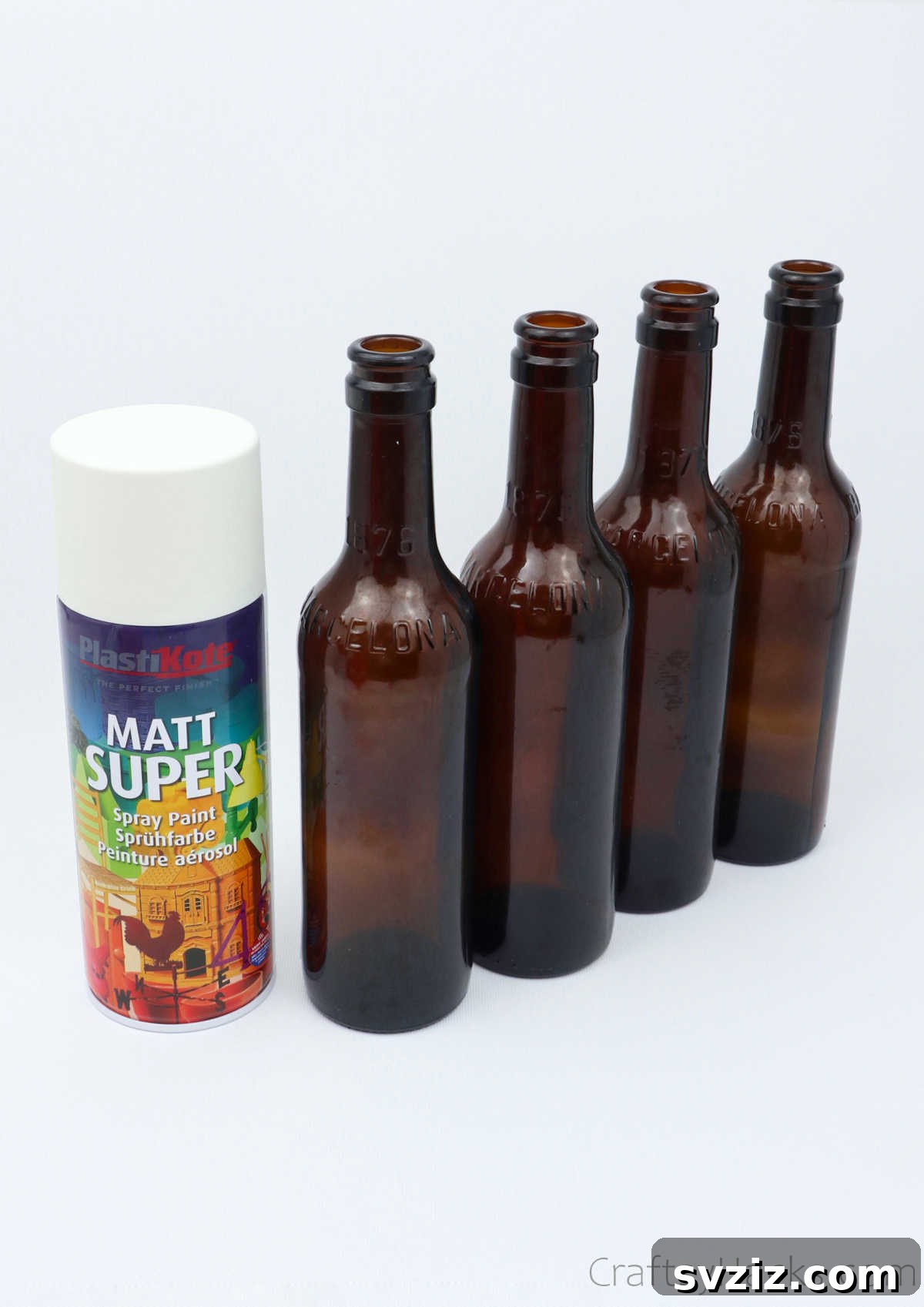 Four beer bottles and a can of white spray paint