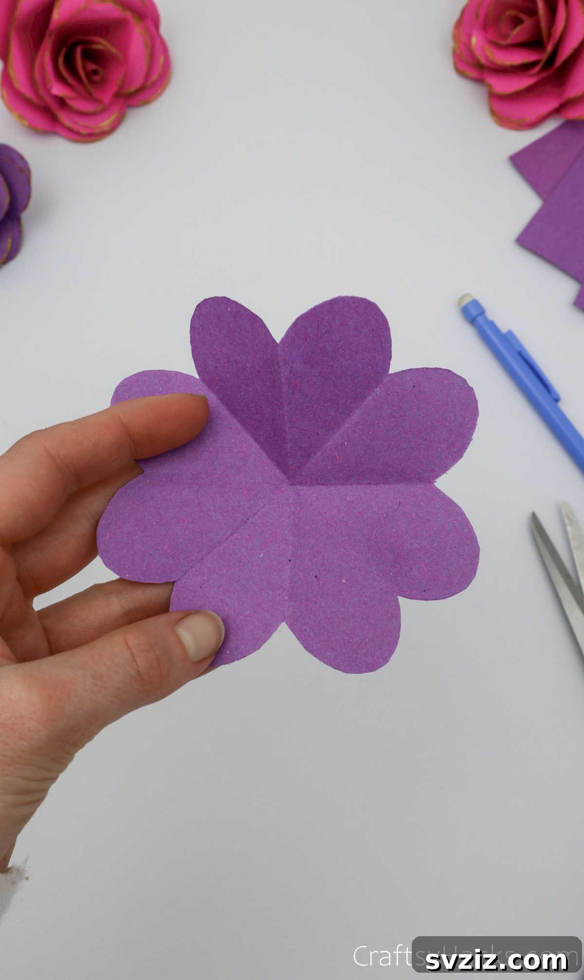 Crafting Beautiful Paper Blooms 12 The unfolded purple paper, revealing the intricate first layer of the flower shape