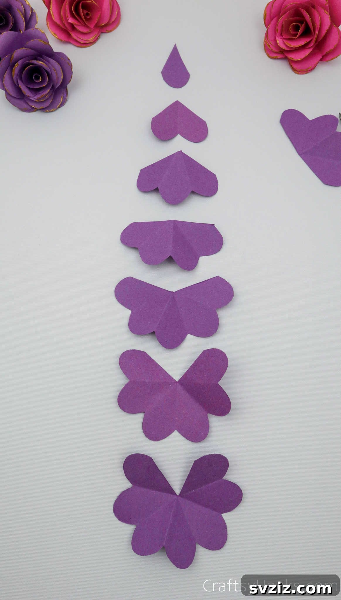 Crafting Beautiful Paper Blooms 16 An organized display of seven purple paper flower cutouts, showing the progressive reduction in size for layering