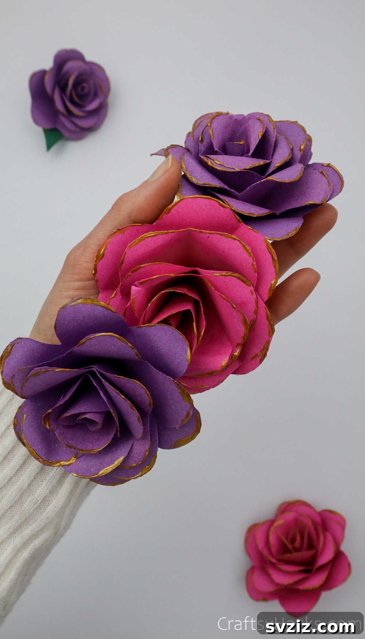 Crafting Beautiful Paper Blooms 3 Hand holding three delicate purple paper flowers with curled petals