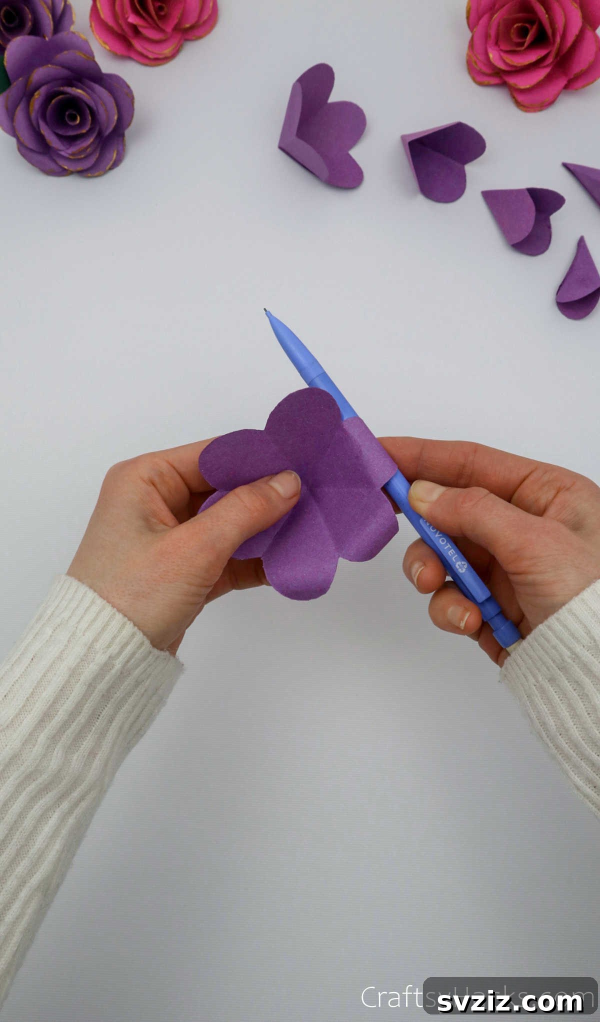 Crafting Beautiful Paper Blooms 22 A hand using a pen to gently curl the edges of a paper flower petal